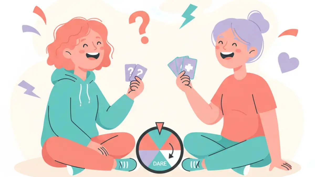 Two teens sitting on the floor laughing while holding truth or dare cards and a spinner